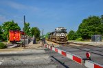 NS 9966 is leading an intermodal train by the AMTRAK station
